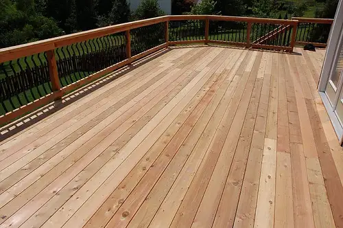 New cedar deck boards with a cedar and black metal railing