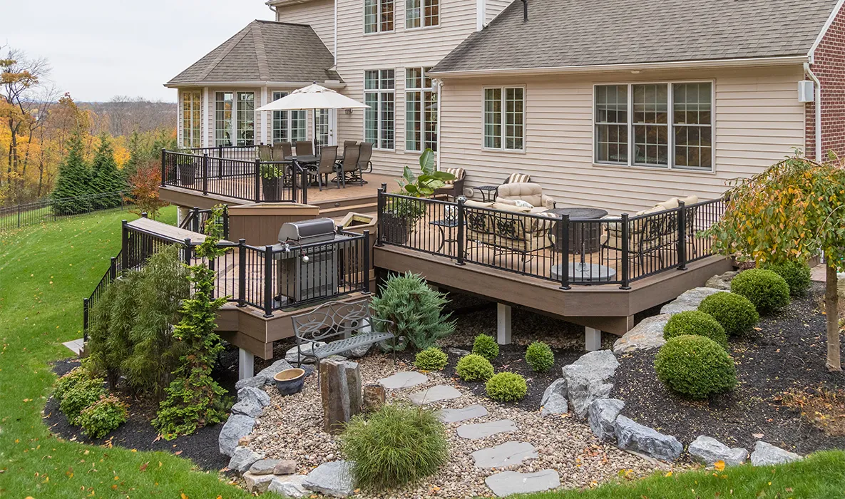 A beautifully crafted deck overlooking an Austin hillside landscape at golden hour