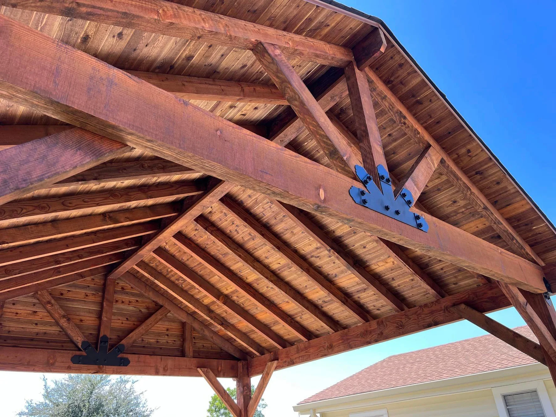 Cedar gable trusses and exposed rafters on a custom patio cover