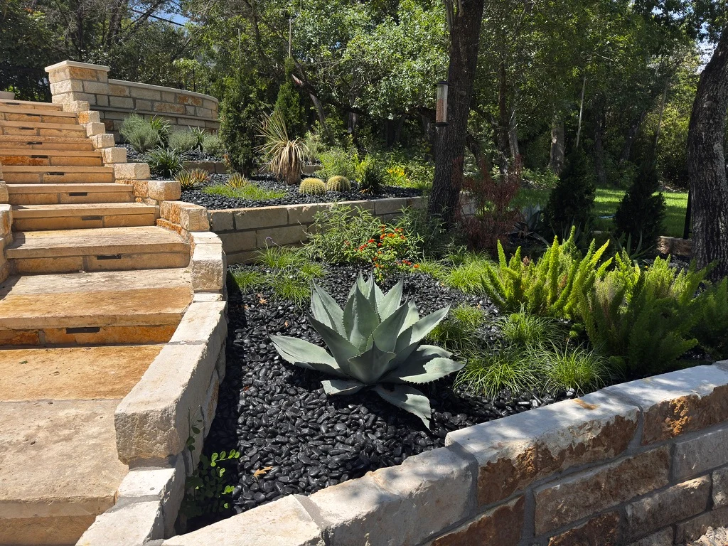 Planting beds with black polished gravel