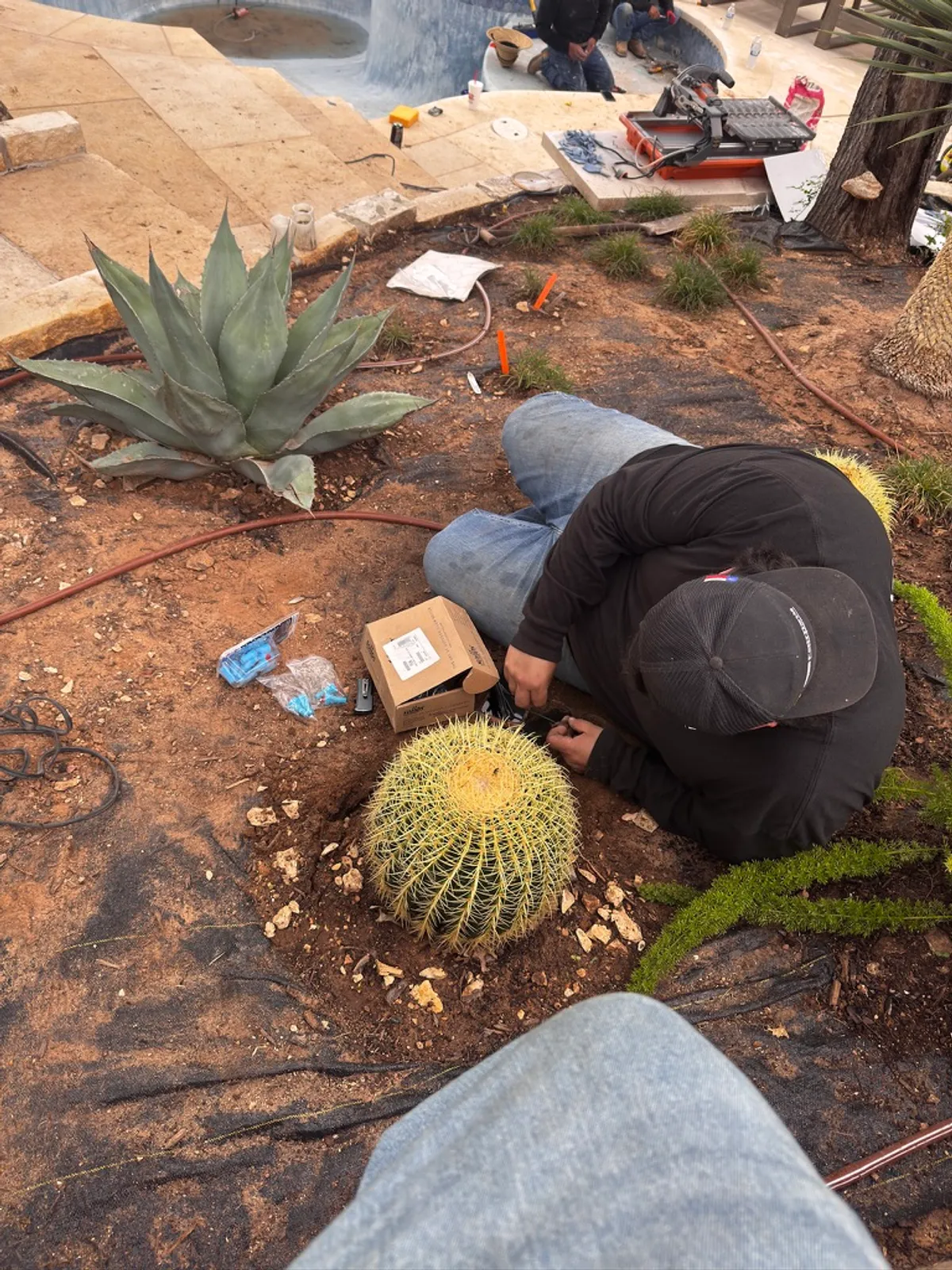 Fairfield Innovations technician installing landscape lighting conduit at a residential property in Austin, TX