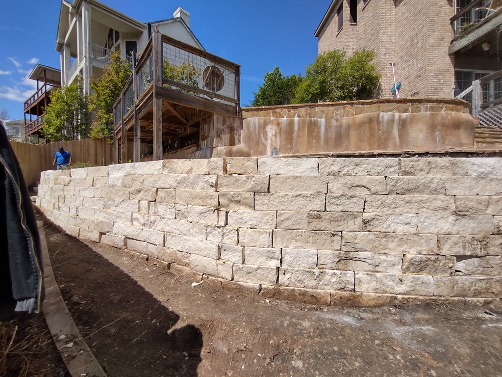 Limestone chopstone retaining wall with natural stone aesthetic