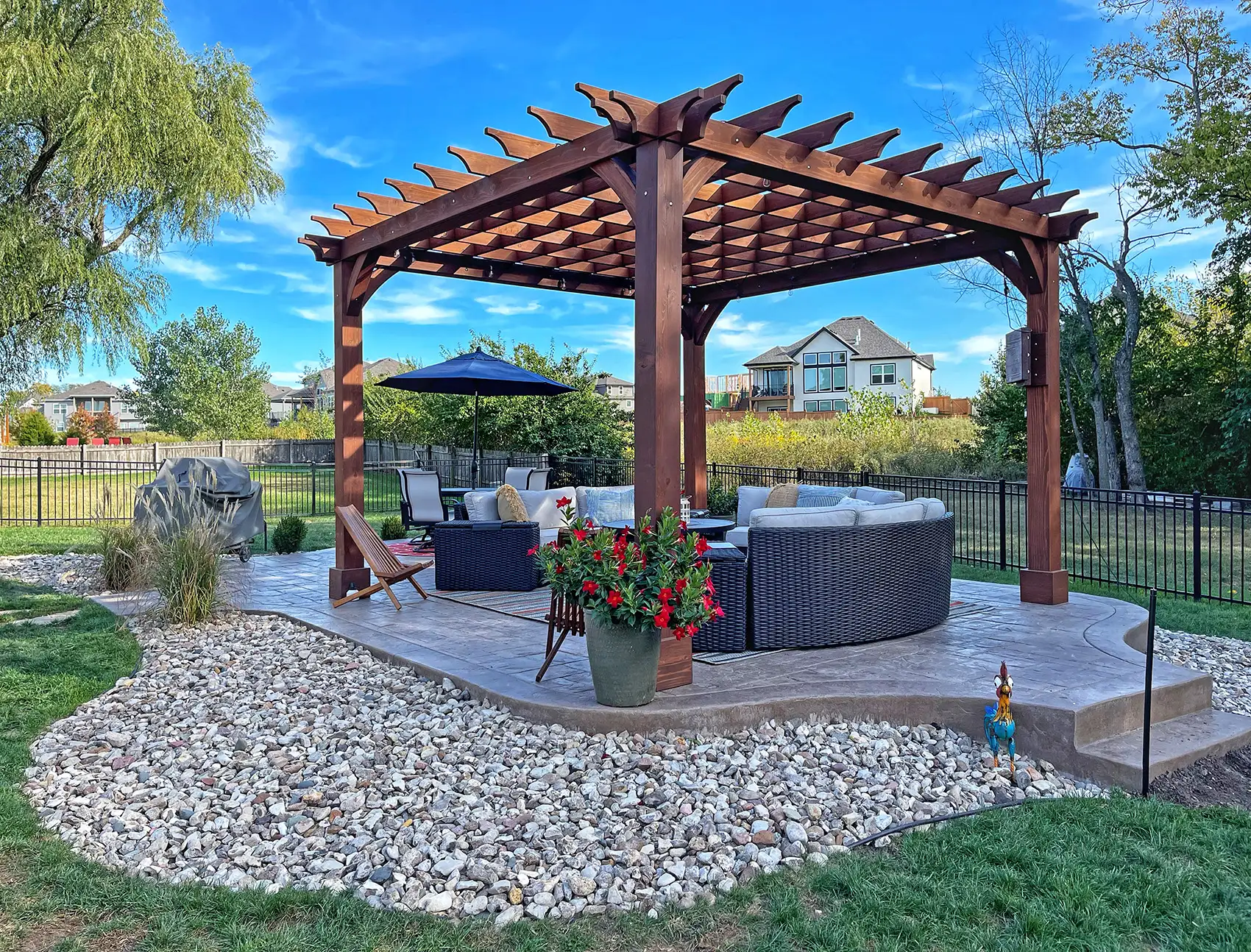 Freestanding cedar pergola over a stamped concrete patio with outdoor seating