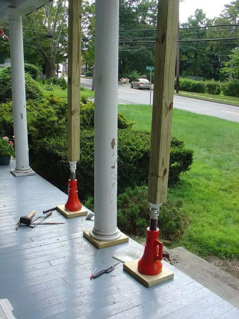 Porch roof held up on jacks while rotted posts are replaced