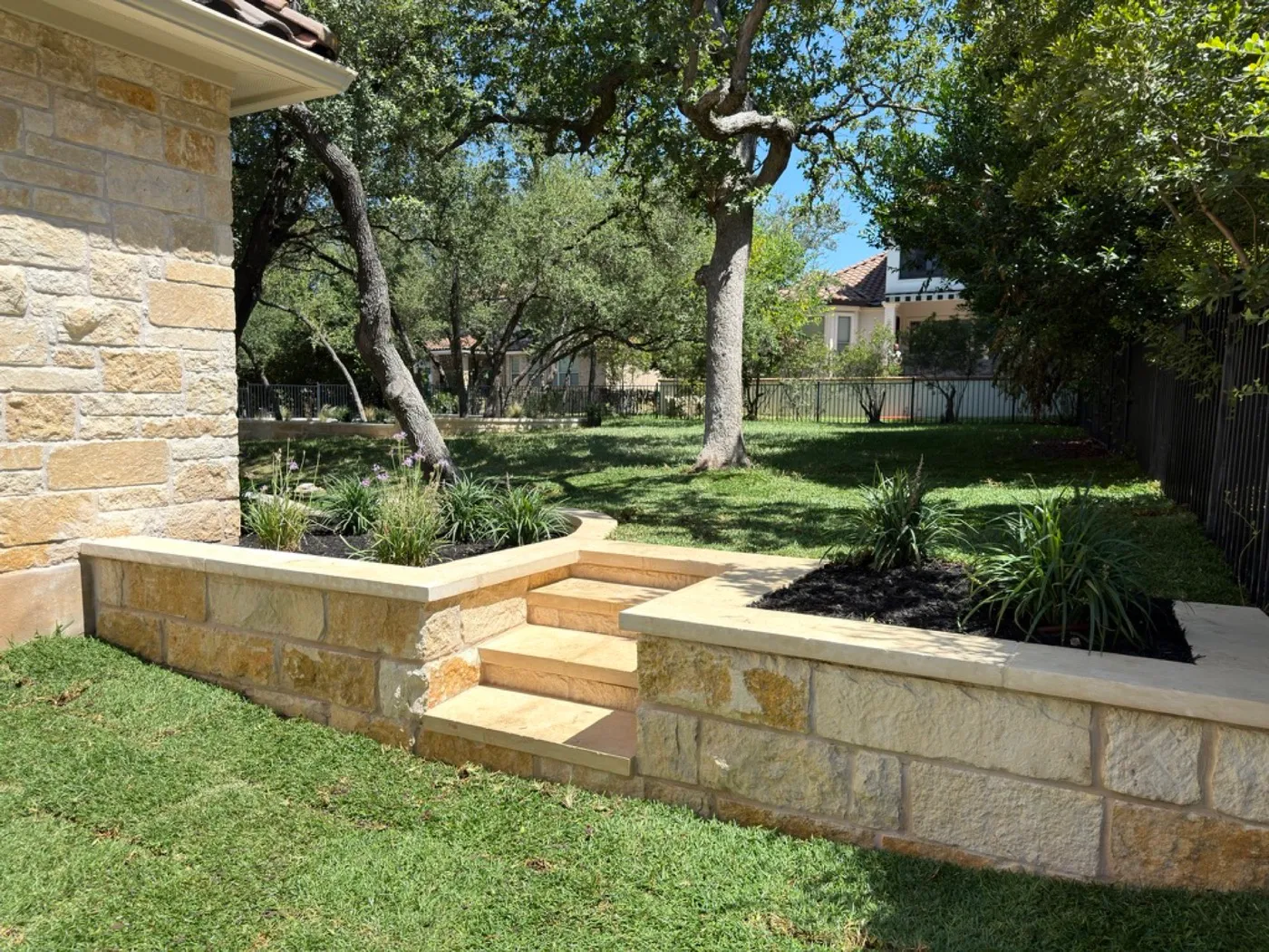 The same two-level raised bed and stone steps as built