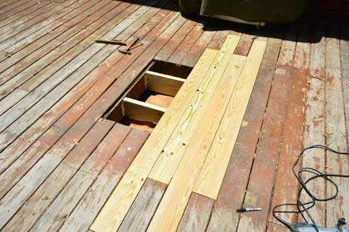 A deck being repaired, deck boards are being replaced